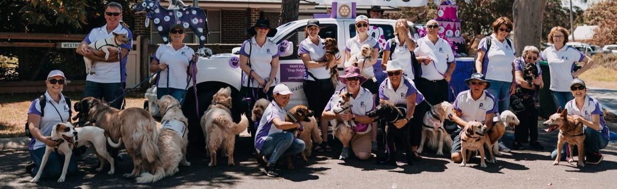 Three hospital nurses with a PAWS therapy dog