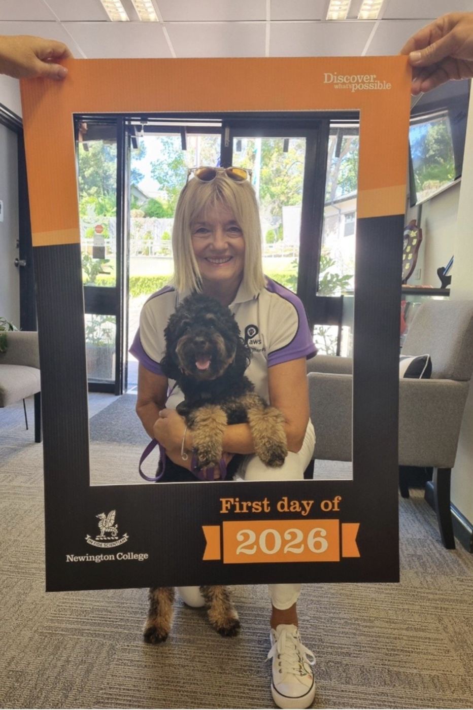 A volunteer and her PAWS therapy dog at a first-day-of-2026 photo booth