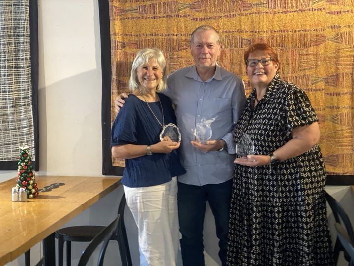 Three people at a PAWS award presentation
